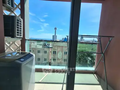 Stunning balcony view with cityscape and washing machine, perfect for urban living.
