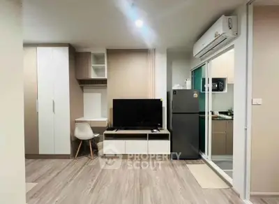 Modern living room with sleek furniture and open kitchen layout in a stylish apartment.