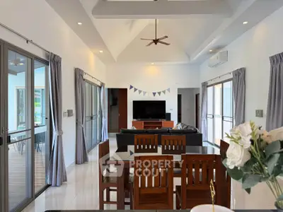 Spacious living room with modern decor and large windows in a stylish home