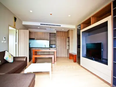 Spacious modern living room with open kitchen and stylish wooden furniture