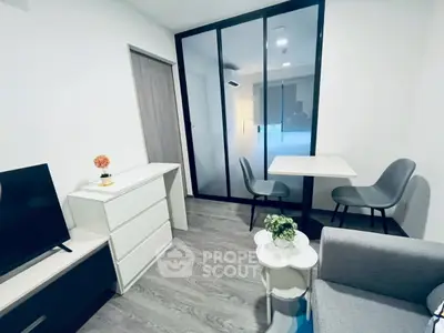 Modern living room with sleek furniture and glass partition, perfect for urban living.