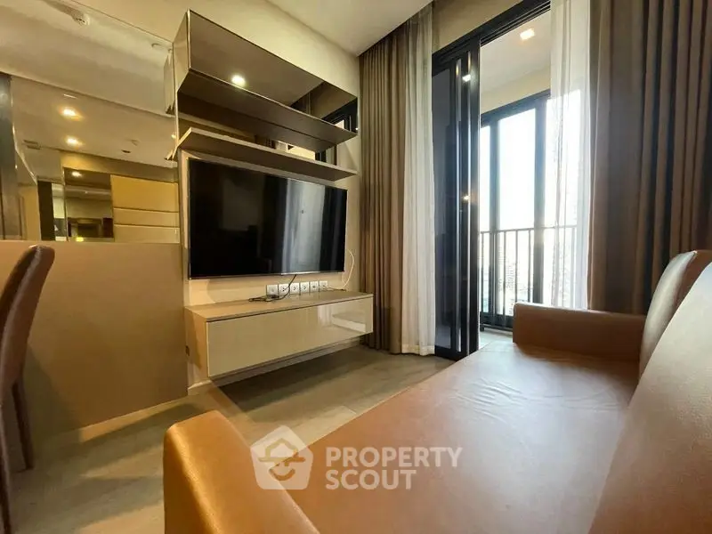 Modern living room with sleek TV setup and balcony access