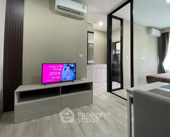 Modern living room with sleek TV stand and air conditioning in stylish apartment.