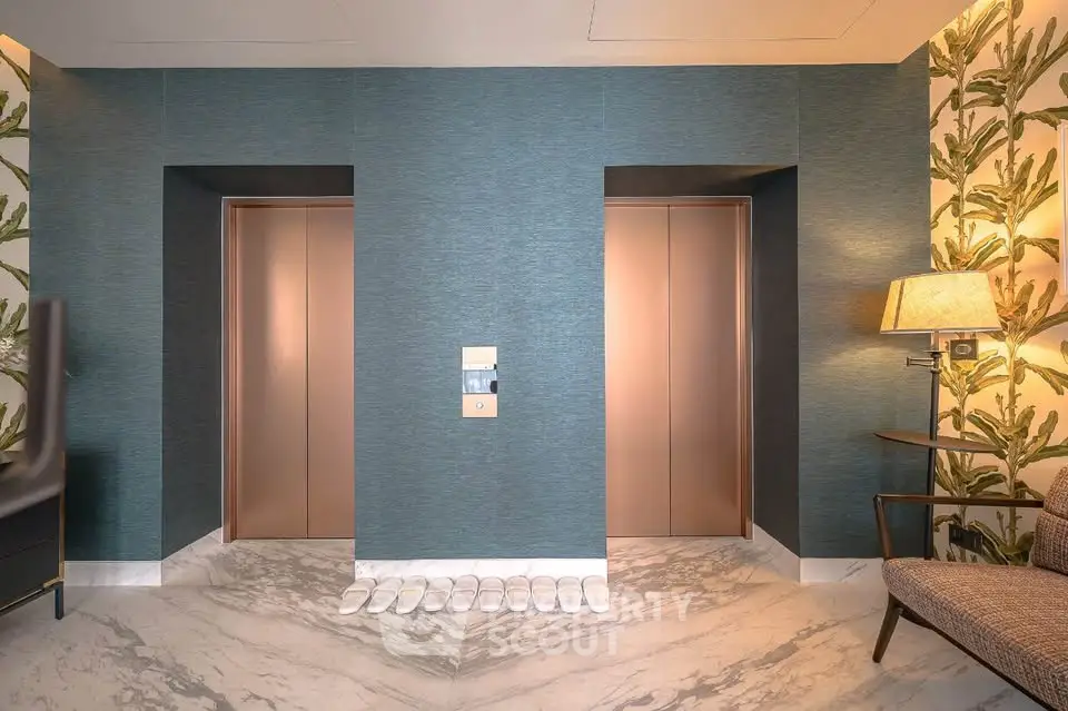 Luxurious modern elevator lobby with elegant decor and marble flooring in upscale building.