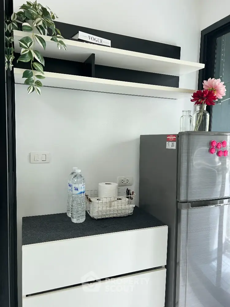 Modern kitchen corner with sleek fridge and stylish shelving