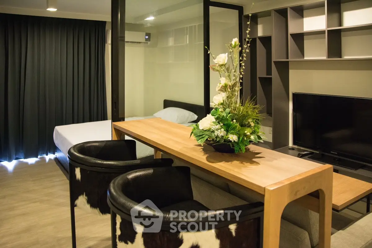 Modern studio apartment with stylish decor and open layout, featuring a cozy living area and elegant furnishings.