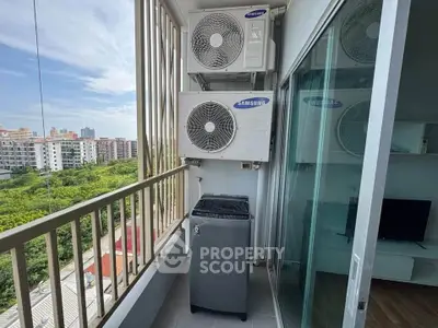 Modern balcony with air conditioning units and washing machine, offering a city view.