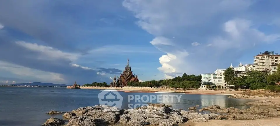 Stunning beachfront view with unique architectural landmark and modern buildings.