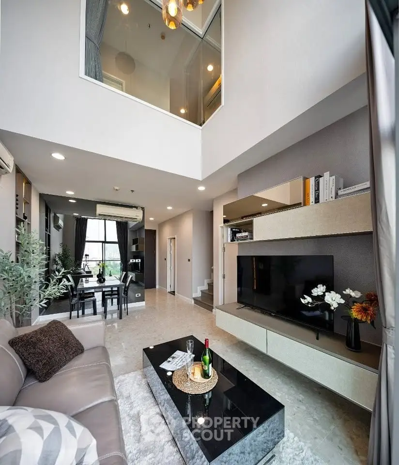 Luxurious modern living room with high ceiling and elegant decor