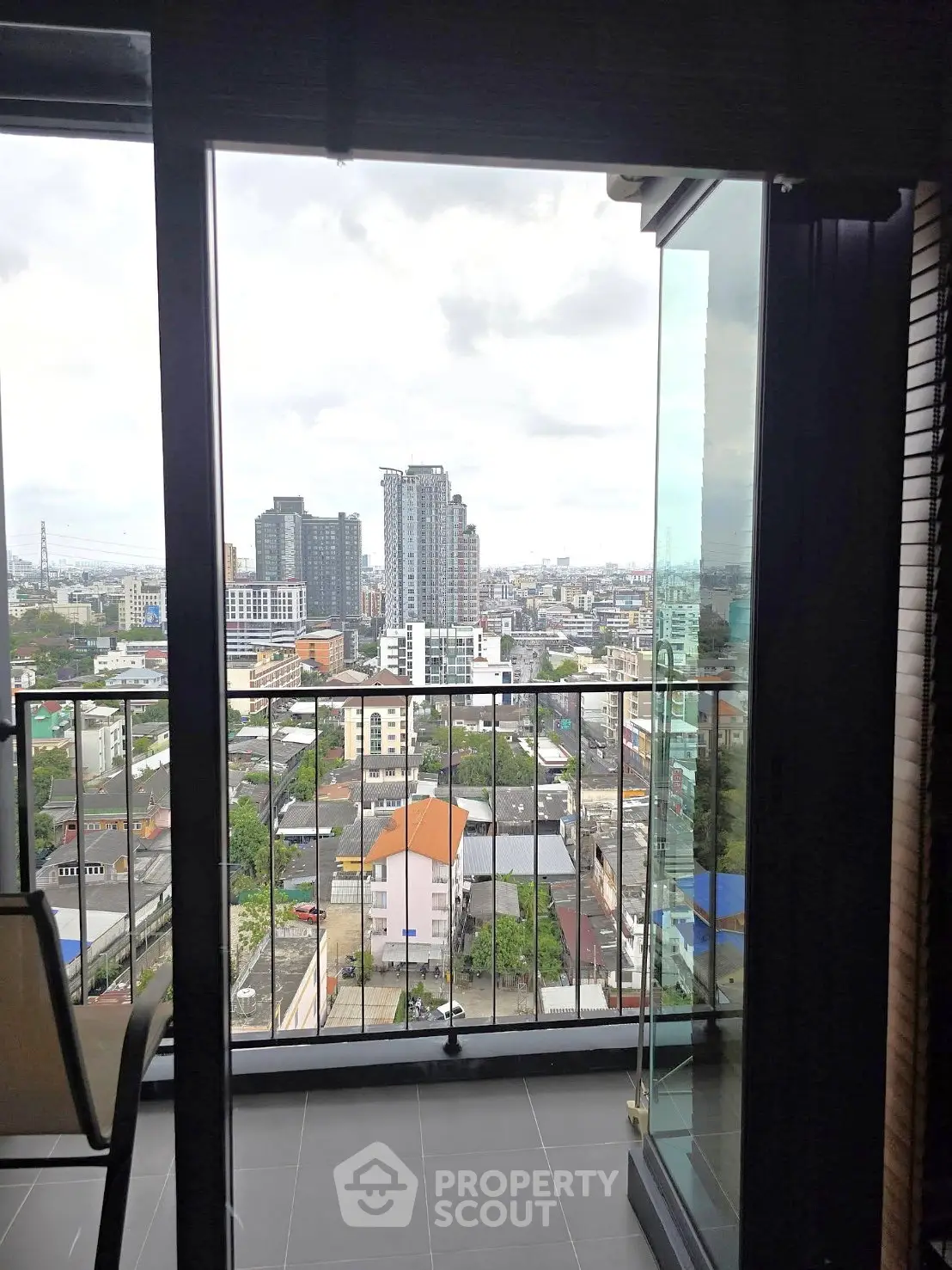 Stunning cityscape view from a modern high-rise balcony, perfect for urban living.