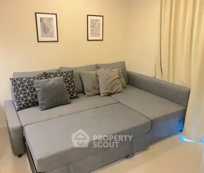 Cozy living room with stylish grey sectional sofa and decorative pillows
