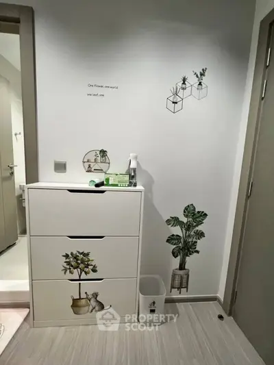 Stylish bathroom with modern decor and plant-themed wall art.