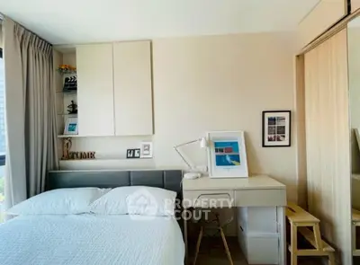 Modern bedroom with stylish decor and natural light, featuring a cozy bed and functional workspace.