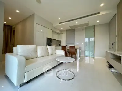 Modern open-plan living room with sleek kitchen and elegant furnishings