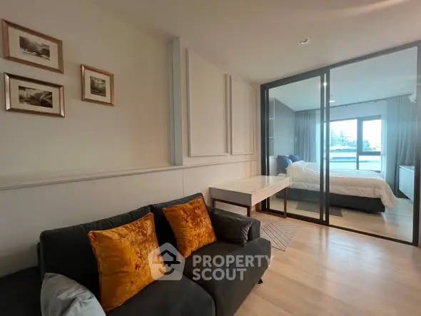 Modern apartment with cozy living room and glass-walled bedroom