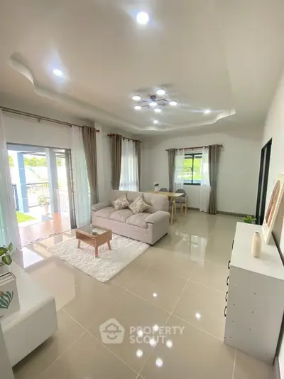 Spacious modern living room with elegant decor and large windows for natural light.