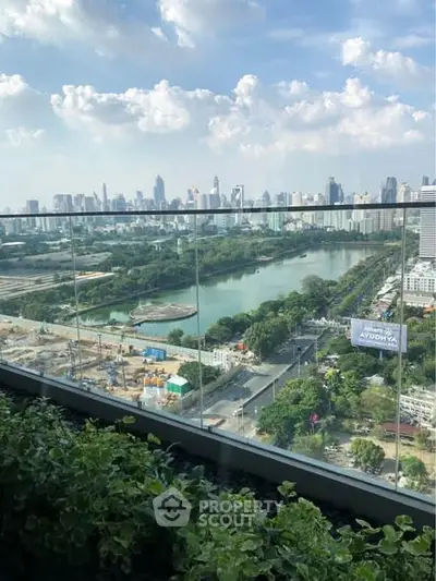 Stunning cityscape view from a high-rise balcony overlooking a river and skyline.