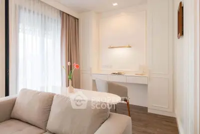 Elegant living room with cozy sofa and stylish study nook, featuring soft lighting and modern decor.