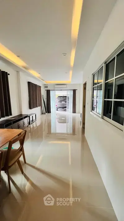 Spacious modern living room with sleek design and large windows