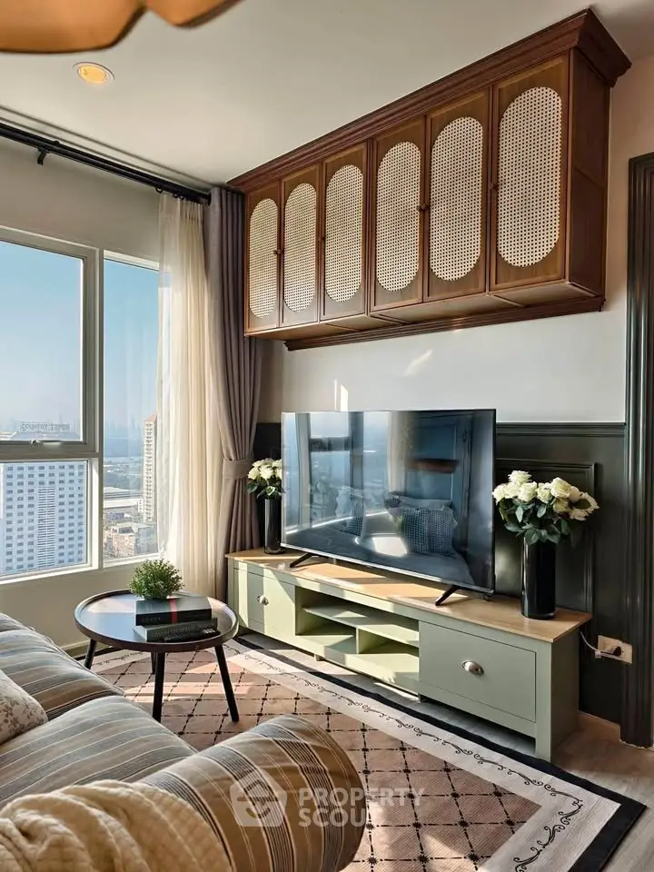 Stylish living room with large window view, modern TV setup, and elegant decor.