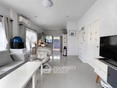 Spacious modern living room with sleek furniture and open layout, perfect for contemporary living.