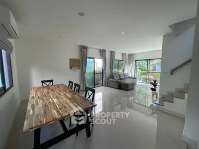 Spacious modern living room with natural light and garden view