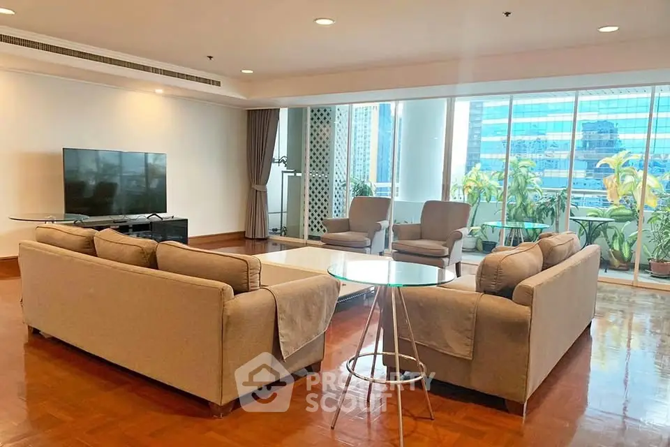 Spacious living room with modern furniture and city view, perfect for urban living.