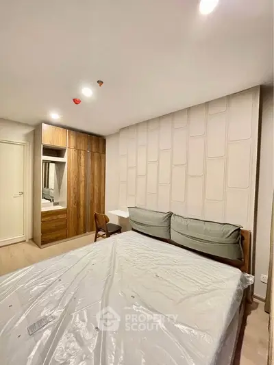 Modern bedroom with stylish wooden wardrobe and cozy bed setup