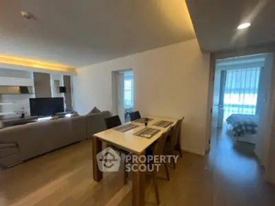 Modern open-plan living and dining area with stylish decor and natural light.