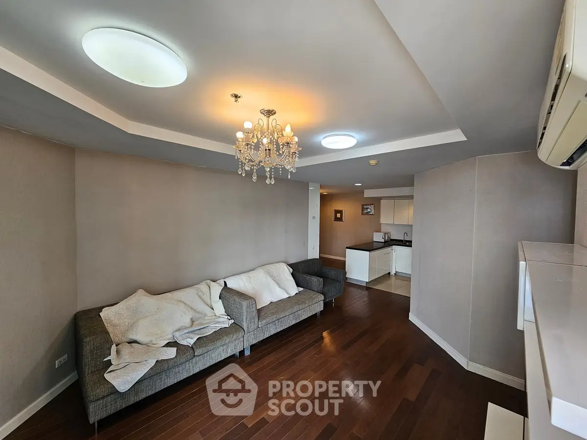 Spacious living room with elegant chandelier and cozy seating area