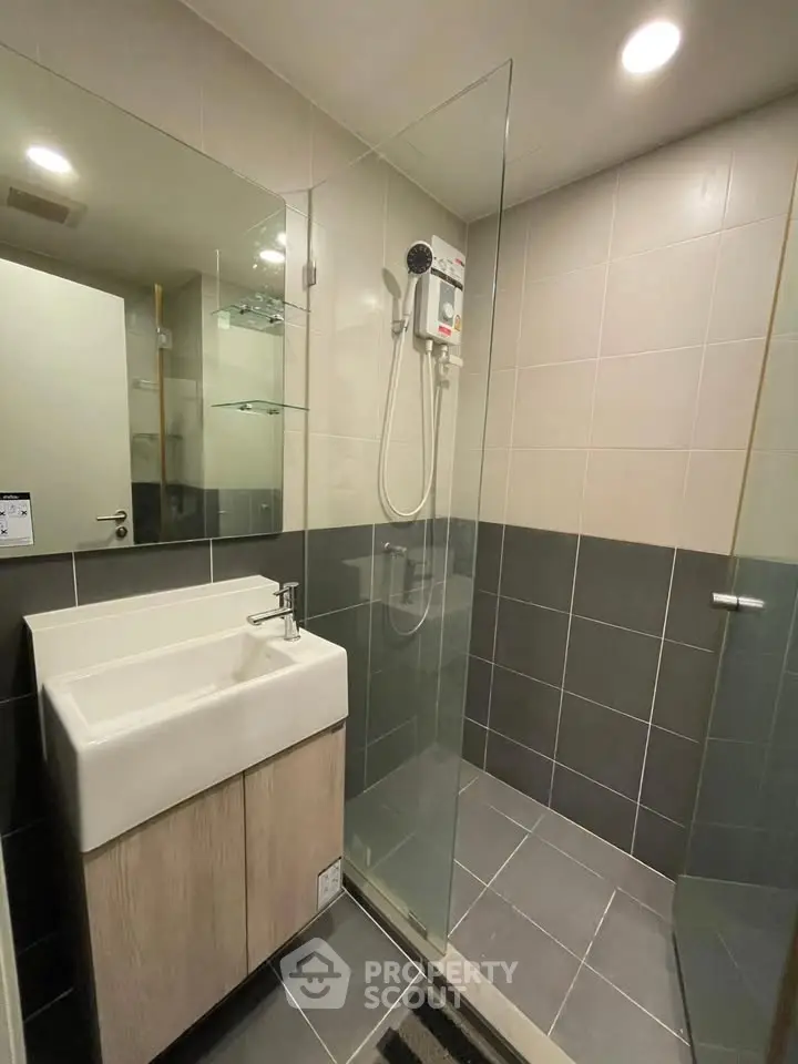 Modern bathroom with glass shower and sleek sink design