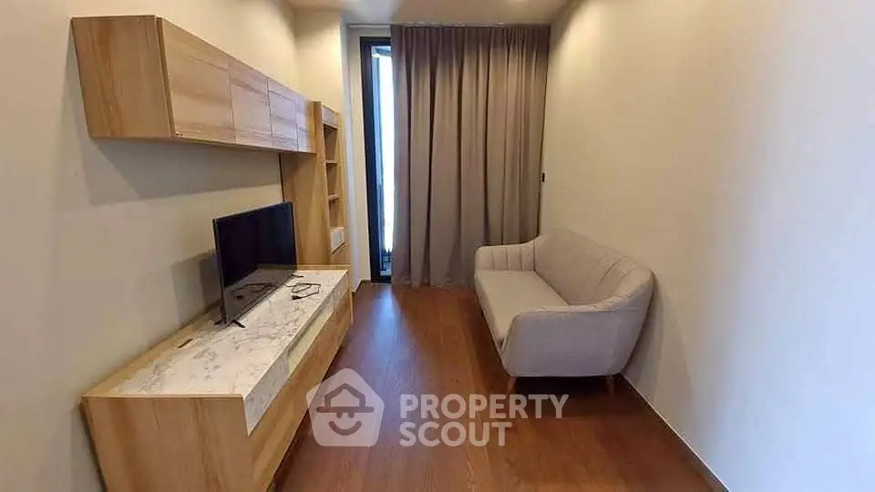Modern living room with sleek wooden furniture and cozy sofa, perfect for relaxation and entertainment.