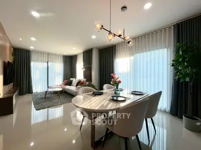 Modern living room with elegant dining area and stylish lighting