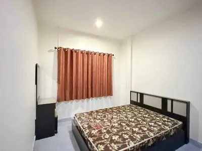 Spacious bedroom with elegant decor and ample natural light
