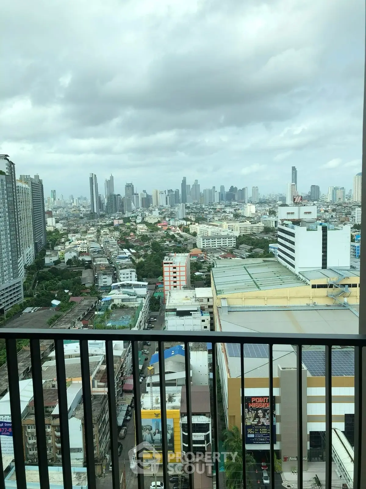 Stunning cityscape view from high-rise balcony overlooking urban skyline.