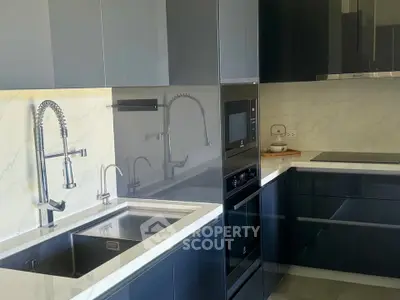 Modern kitchen with sleek cabinetry and high-end appliances