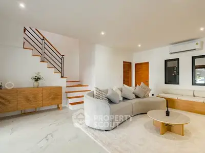 Spacious modern living room with stylish furniture and elegant staircase