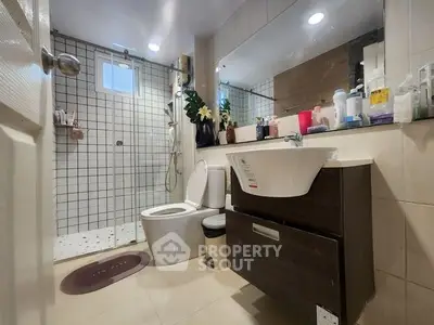 Modern bathroom with sleek fixtures and glass shower enclosure
