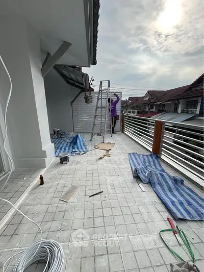 Spacious balcony under renovation with scenic neighborhood view