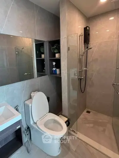 Modern bathroom with sleek shower and elegant fixtures in a contemporary apartment.