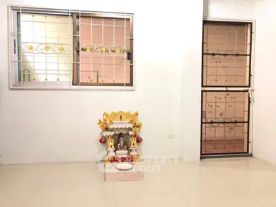 Spacious interior with decorative altar and secure window grilles