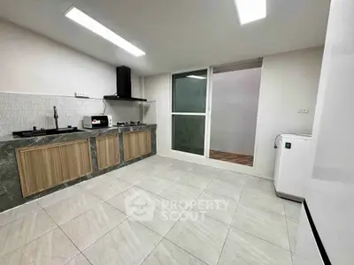 Modern kitchen with sleek cabinetry and gas stove in a spacious layout