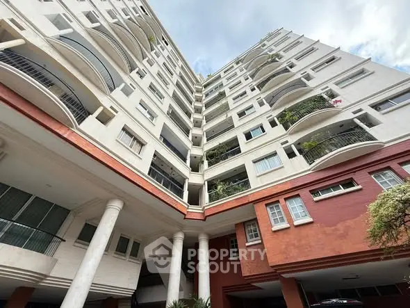 Stunning multi-story residential building with modern architectural design and spacious balconies.