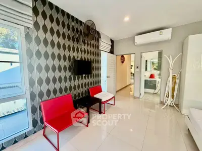 Modern living room with red chairs and stylish wallpaper