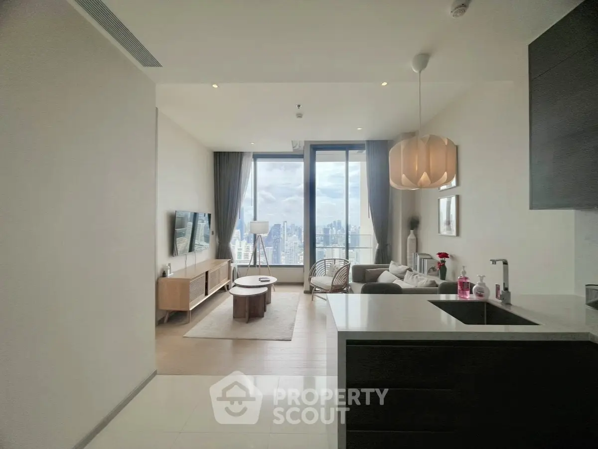 Modern living room with stunning city view, stylish furniture, and open layout in high-rise apartment.
