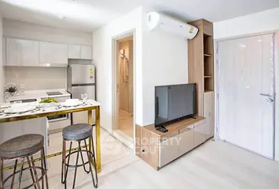Modern open-plan kitchen and living area with stylish decor and natural light.