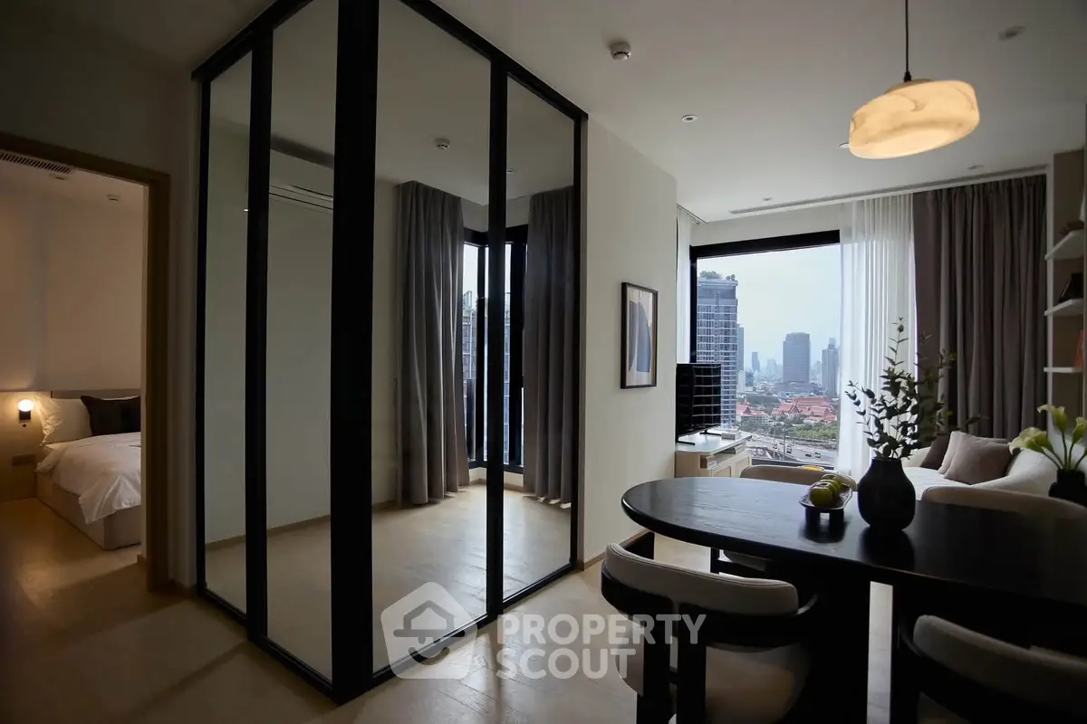 Modern apartment with city view, featuring a stylish living area and dining space, perfect for urban living.