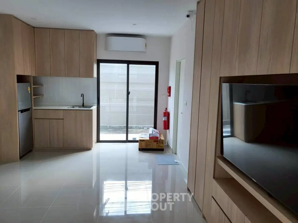 Modern kitchen with sleek cabinetry and large window for natural light