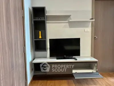 Modern living room with sleek TV unit and wooden flooring
