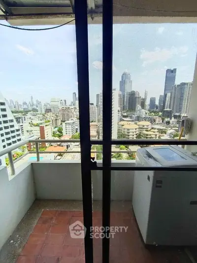 Stunning city view from high-rise balcony with modern skyline backdrop.
